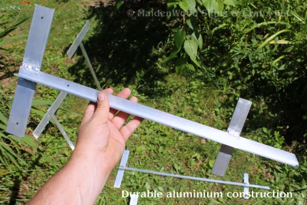 Aluminum sign post holder stake being held, showing its sturdy welded construction for holding outdoor PVC or wood signs.